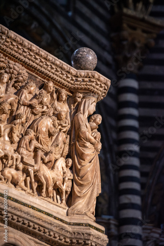 SIENA, ITALY - SEPTEMBER 23, 2023 - Mother mary with child at the marble pulpit in the Siena cathedral, designed by Niccolo Pisano