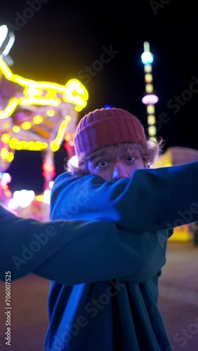 Fashion teen man performing contemporary dance at evening amusement park