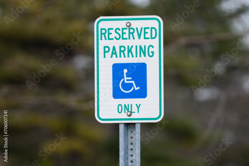 mounted sign sign says reserved parking for handicap only