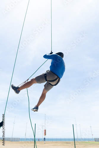 Rappelist hanging from the rope doing tricks. Healthy and dangerous sport.