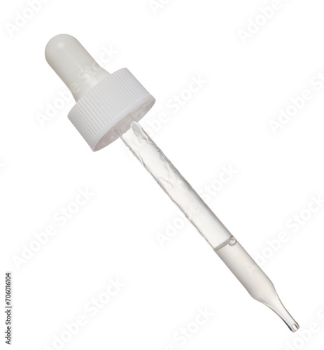 Transparent glass pipette with white liquid on isolated background photo