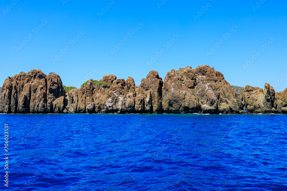 Rocky coast in the resort part of the Mediterranean or Aegean Sea. Background with selective focus and copy space Rocky coast in the resort part of the Mediterranean or Aegean Sea. Background with selective focus and copy space
