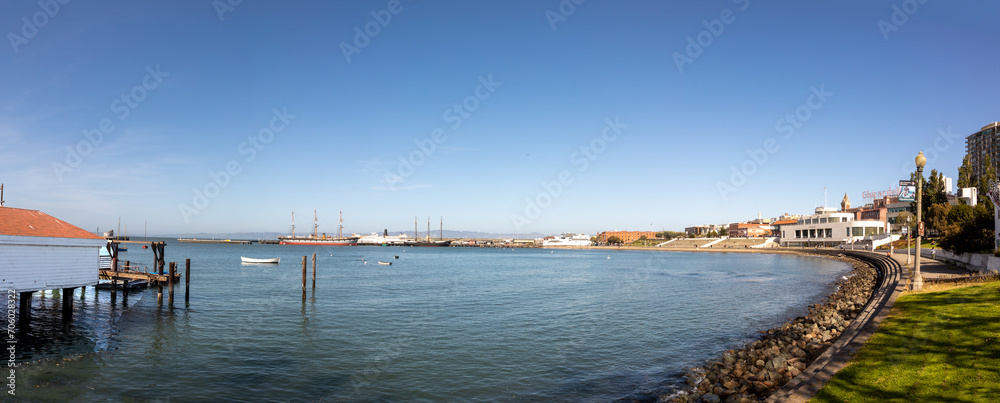 panoramic view to pier in San Francisco with modern buildings and old traditional pier and historic ships,