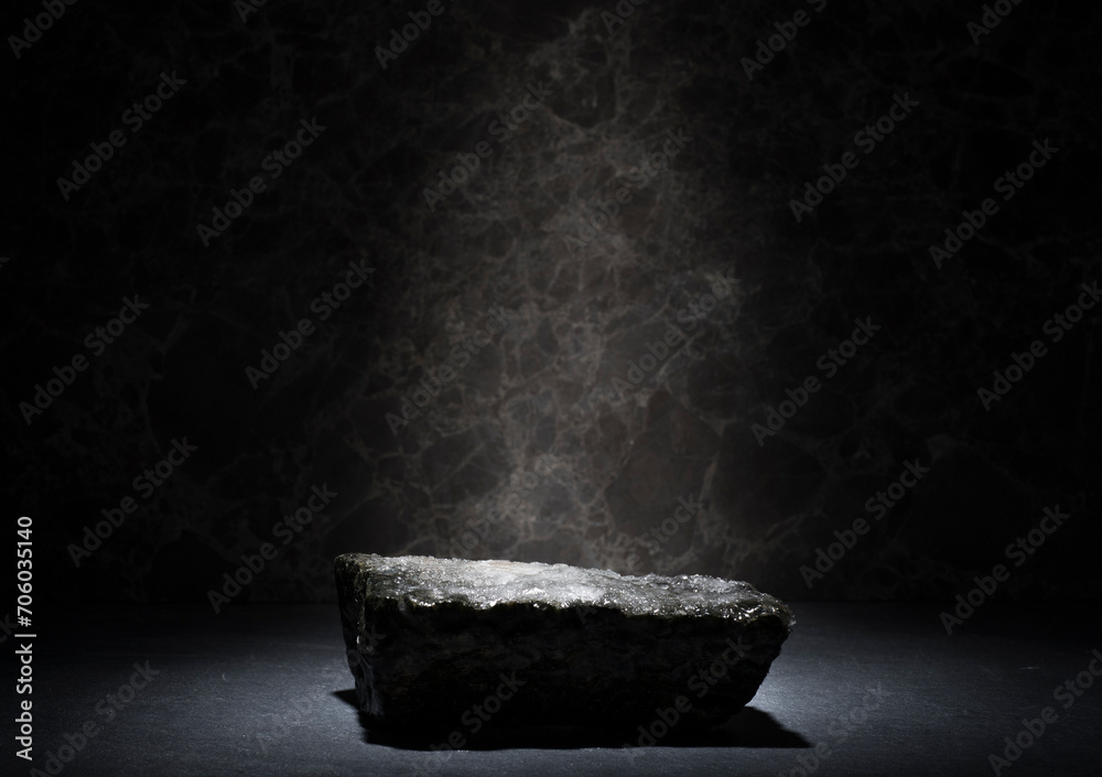stones and ice for the podium. natural black stones in a thin layer of ice on a dark background for the presentation of a product cosmetics medicine perfumery jewelry - obrazy, fototapety, plakaty 