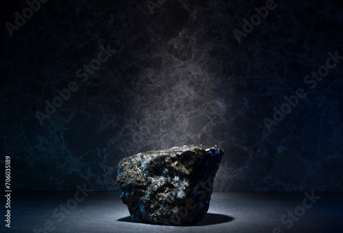 stones and ice for the podium. natural black stones in a thin layer of ice on a dark background for the presentation of a product cosmetics medicine perfumery jewelry photo
