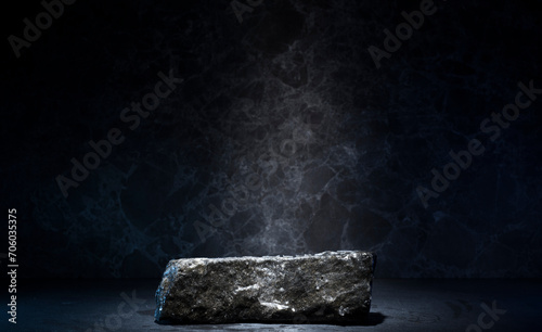 stones and ice for the podium. natural black stones in a thin layer of ice on a dark background for the presentation of a product cosmetics medicine perfumery jewelry