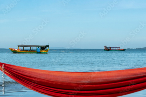 Boats on the sea with blurred hammock in the foreground