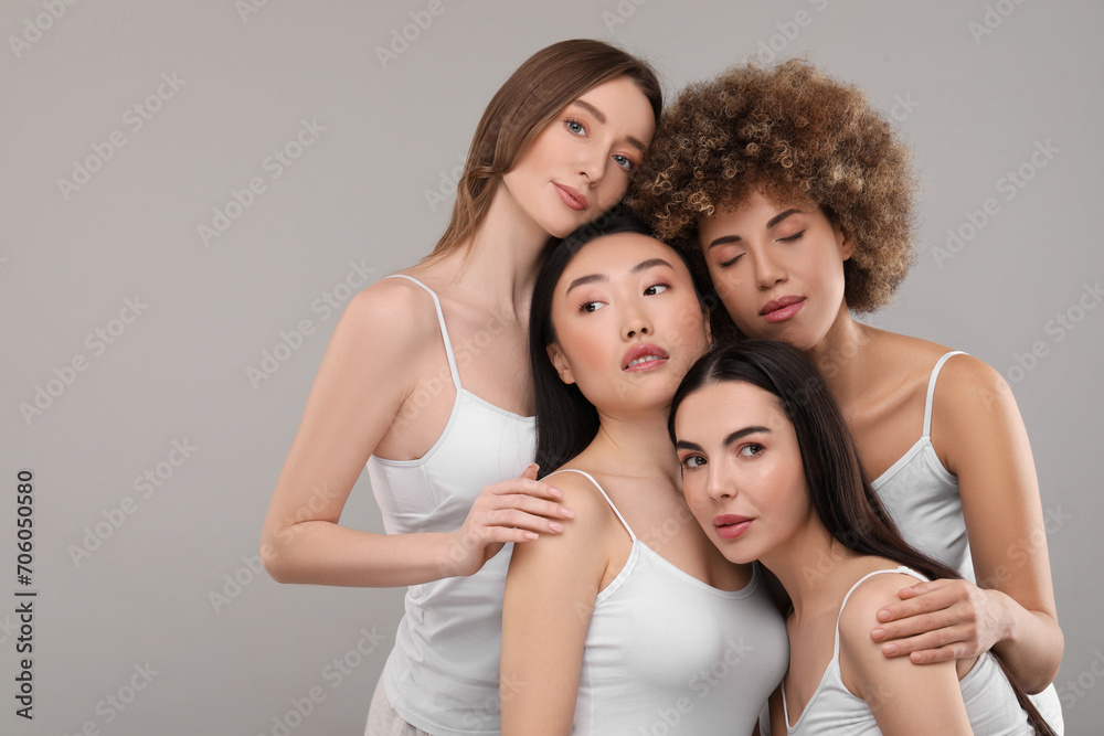 Beautiful young women with healthy skin on gray background, space for text Beautiful young women with healthy skin on gray background, space for text