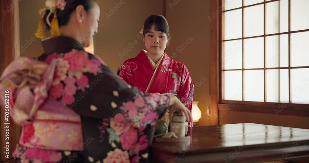 Traditional Japanese women, friends and tea with bow for respect, kindness or relax together at table. Girl, people and ceremony with drink for culture, fashion or indigenous clothes with cup in home Traditional Japanese women, friends and tea with bow for respect, kindness or relax together at table. Girl, people and ceremony with drink for culture, fashion or indigenous clothes with cup in home