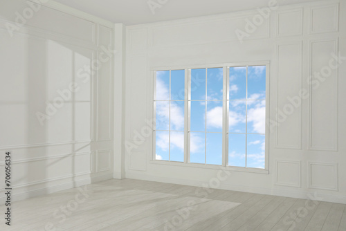 Empty room with white walls and large window