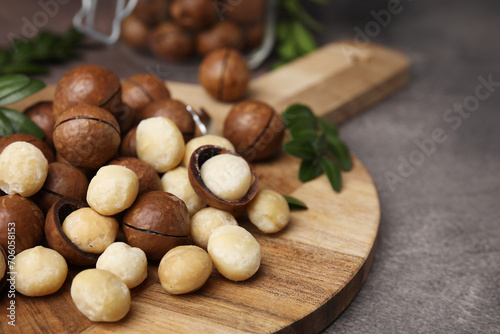 Tasty organic Macadamia nuts on grey table, closeup. Space for text