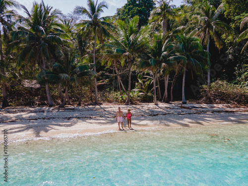 Koh Wai Island Thailand tropical Island near Koh Chang, couple of men and woman on the beach © Fokke Baarssen