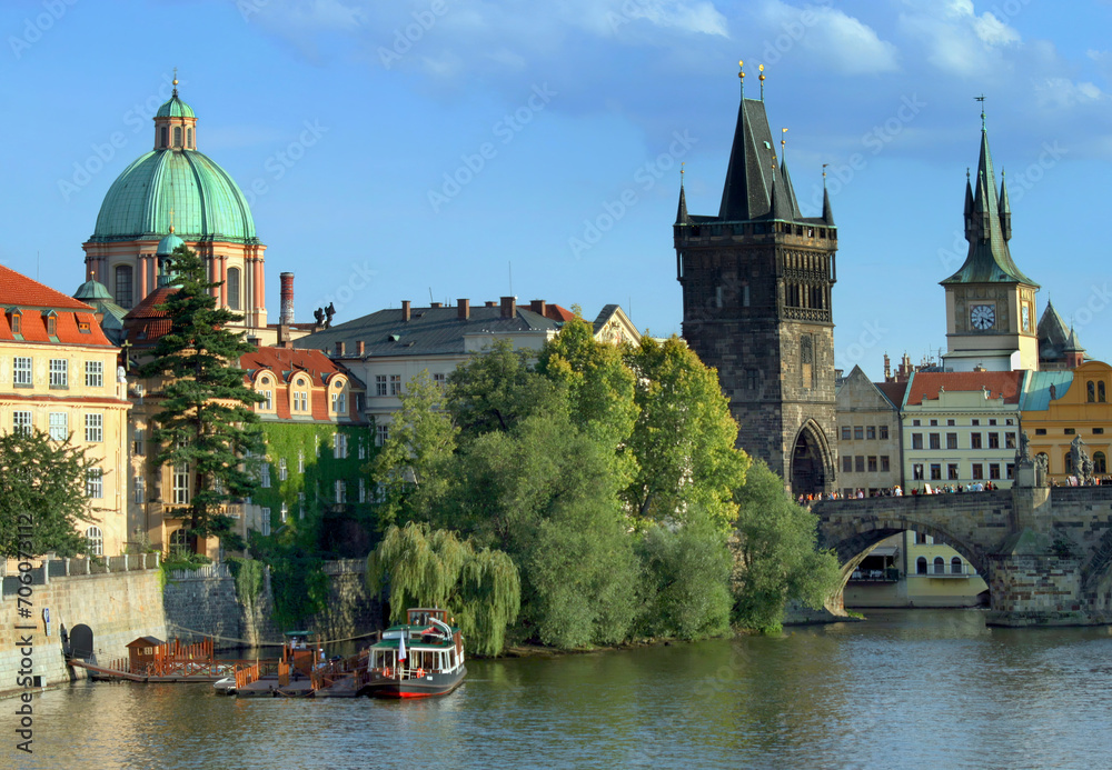 Beautiful historical part of the capital city of Prague, Czech Republic. Charles Bridge on the Vltava River, Francis of Assisi Church and Tower. Tourism and travel.