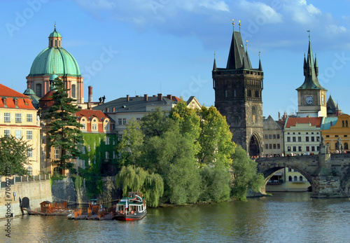 Beautiful historical part of the capital city of Prague, Czech Republic. Charles Bridge on the Vltava River, Francis of Assisi Church and Tower. Tourism and travel.