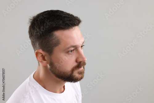 Man with healthy hair on grey background. Space for text
