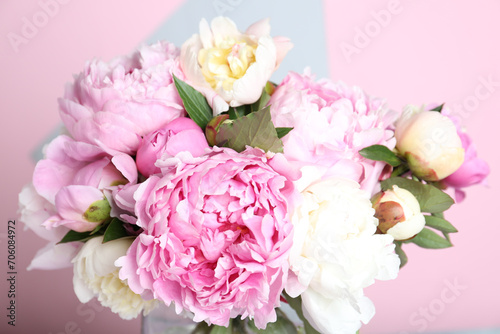 Bouquet of beautiful peonies on color background, closeup