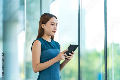 Young Asian Woman Using Digital Tablet to Manage Her Tasks Remotely While Out Of Office Free Download Young Asian Woman Using Digital Tablet to Manage Her Tasks Remotely While Out Of Office - GFXLoad