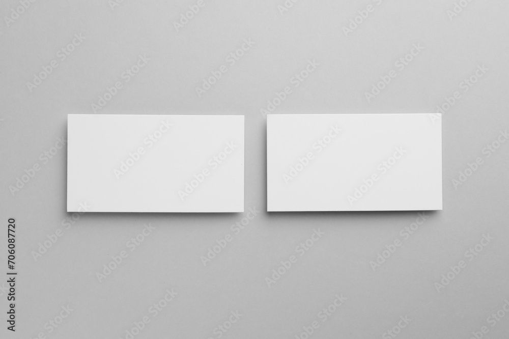 Blank business cards on light gray background, top view. Mockup for design Blank business cards on light gray background, top view. Mockup for design