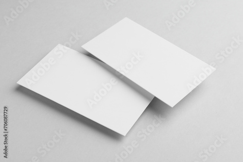 Blank business cards on light grey background. Mockup for design