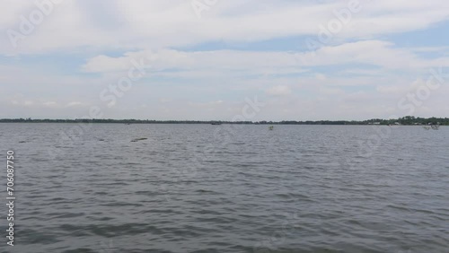 A view of the marsh water from a moving boat. Scenery of wetland water in Haor, Sunamganj, Bangladesh. photo