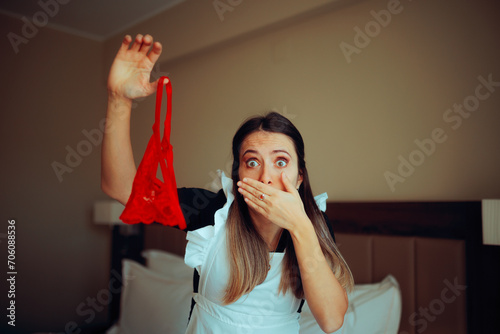 Funny Surprised Hotel Maid Finding Underwear in a Room. Housekeeper discovering the mistress pantries after cleaning up 
 photo