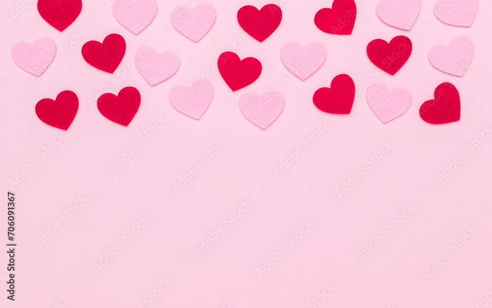 Carved red and pink hearts on a pink background.