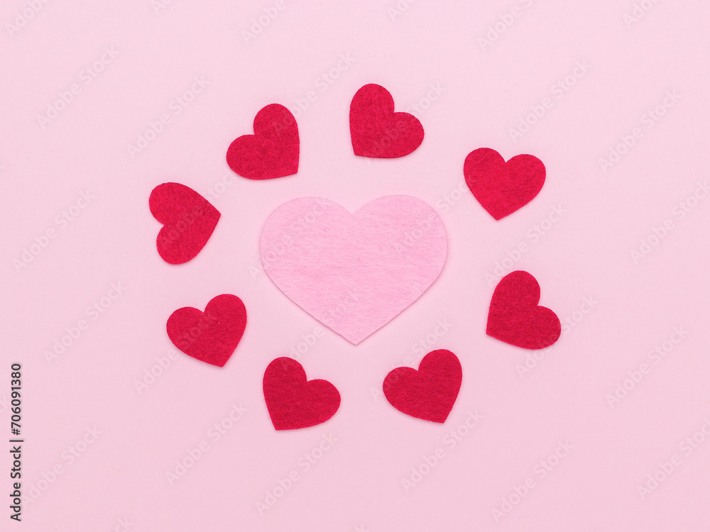 A large pink heart and several small ones on a pink background.