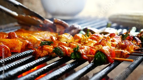 BBQ Barbecue grilled meat stick on fire flame with hot charcoal cooking outside. Beef grilling picnic outdoor with smoke bacon spicy sausage for party. Grill pork bbq on fire flame