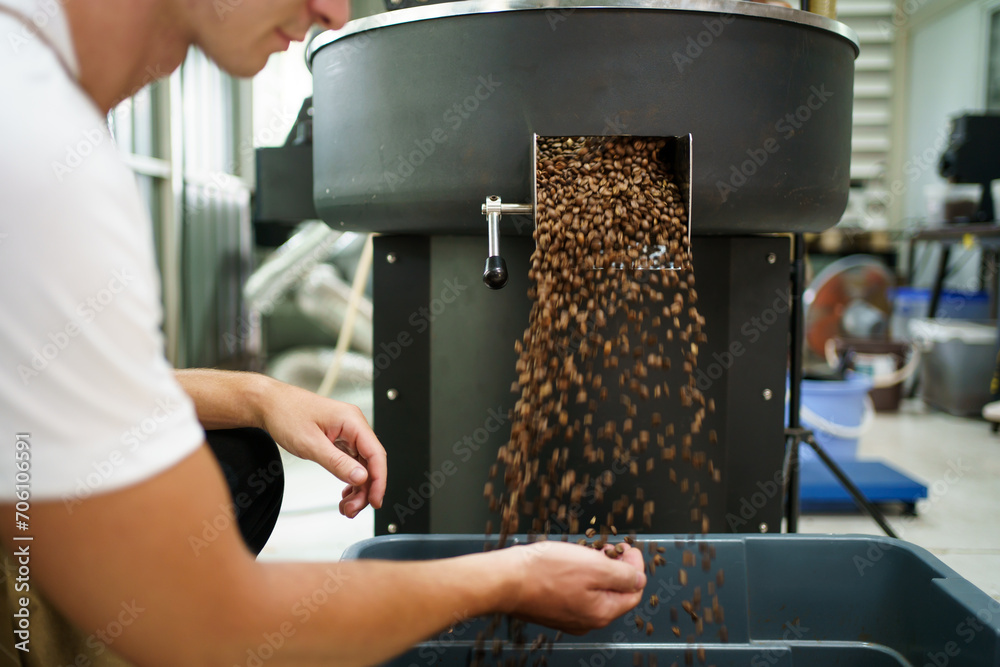 Coffee roasting specialist checking or inspecting quality of roasted coffee beans.