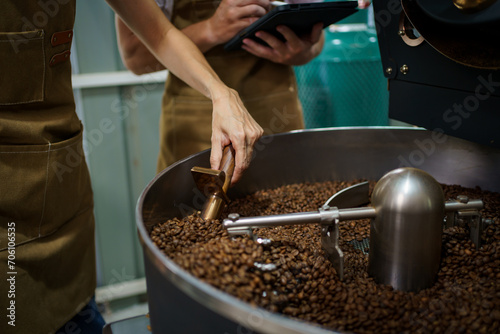 Coffee roasting specialist checking or inspecting quality of roasted coffee beans.