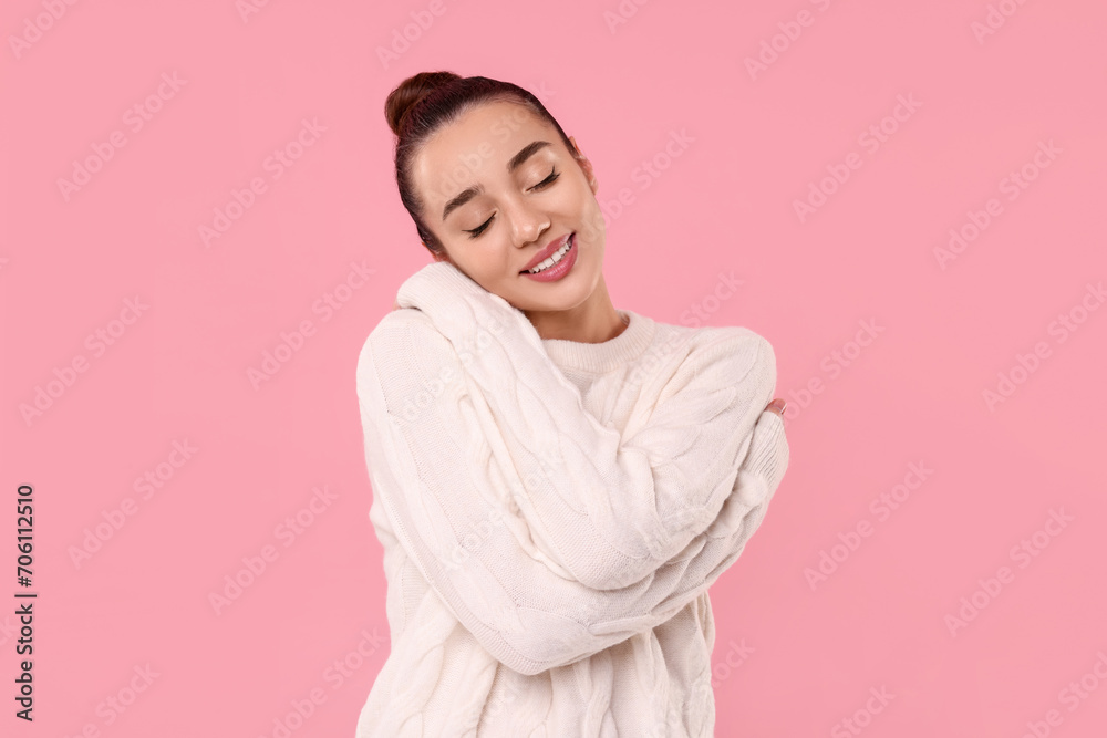 Beautiful young woman in stylish warm sweater on pink background Beautiful young woman in stylish warm sweater on pink background