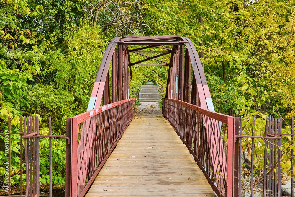 Rustic Metal Truss Bridge in Lush Park with Autumn Foliage, Eye-Level View Rustic Metal Truss Bridge in Lush Park with Autumn Foliage, Eye-Level View