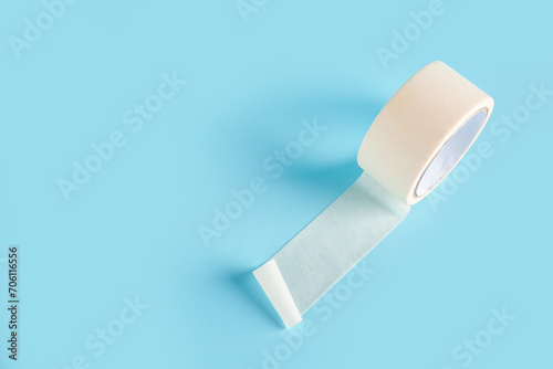 Adhesive tape roll on blue background