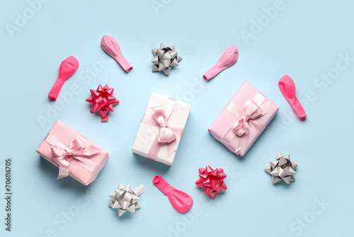 Composition with birthday gift boxes and balloons on pale blue background