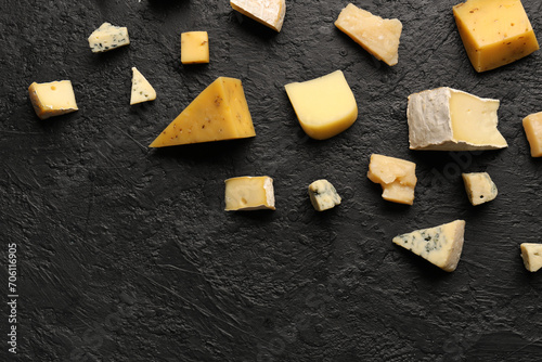 Pieces of tasty cheese on dark background