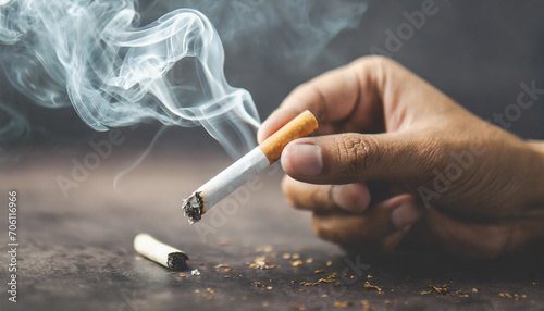 Close-up of hand crushing a burning cigarette, symbolizing determination to quit smoking photo