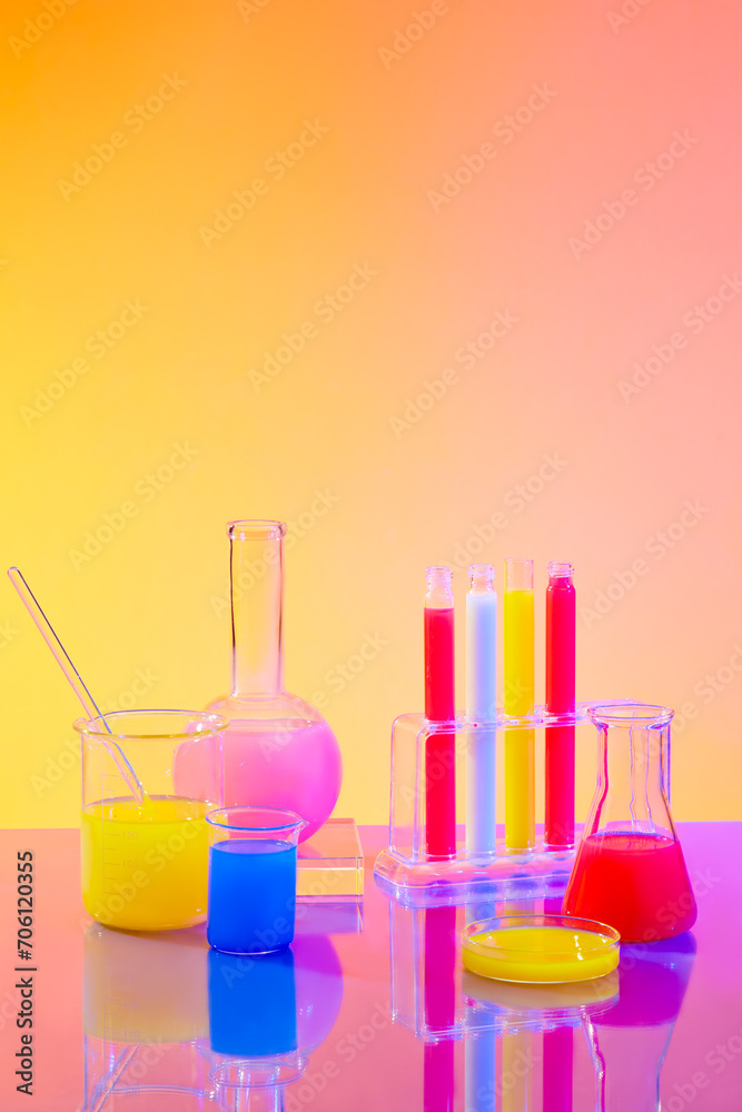Colorful liquids are contained in glassware on a gradient background in an experimental environment. Advertising space with laboratory concept. Colorful liquids are contained in glassware on a gradient background in an experimental environment. Advertising space with laboratory concept.