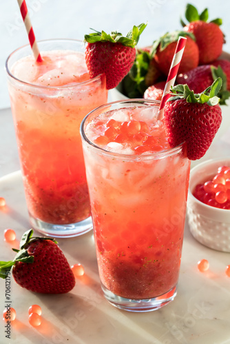 Glasses of fresh homemade strawberry lemonade with bubble pearls.