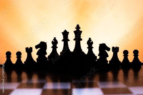 Ajedrez. Wallpaper de contraluces de piezas de ajedrez con una luz amplia por detras calida motivadora. photo