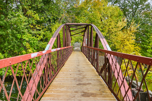 Autumnal Steel Truss Pedestrian Bridge in Park Serenity