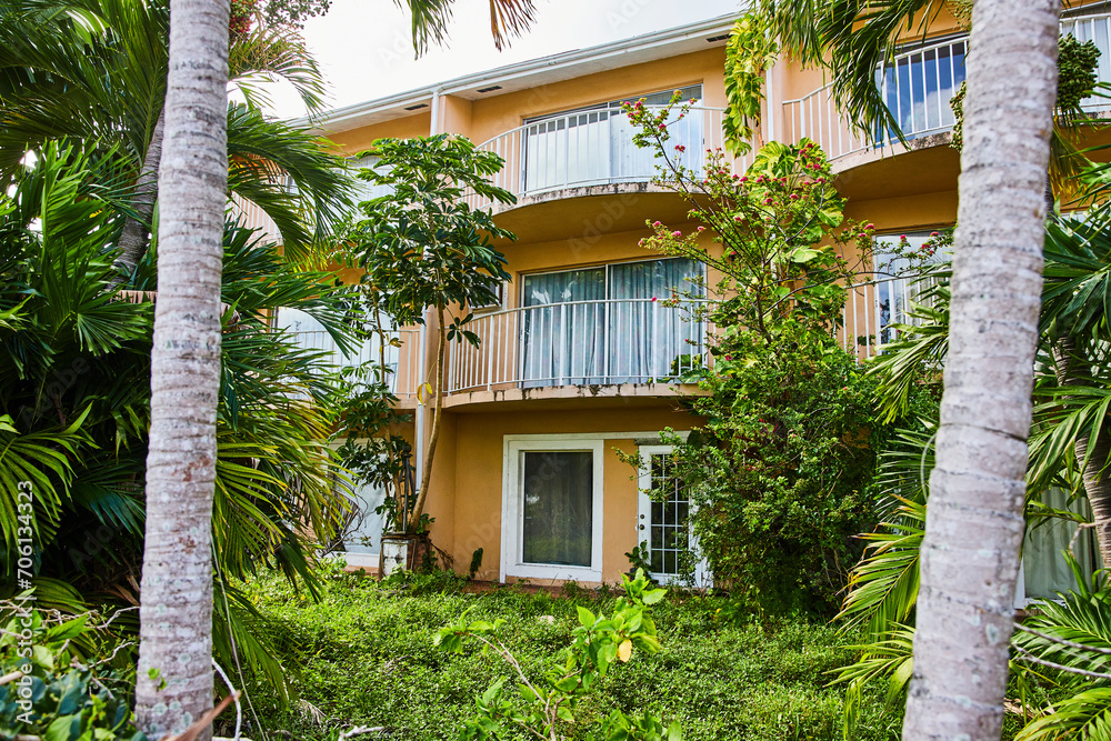 Tropical Yellow House with Balcony in Lush Greenery, Bahamas Tropical Yellow House with Balcony in Lush Greenery, Bahamas