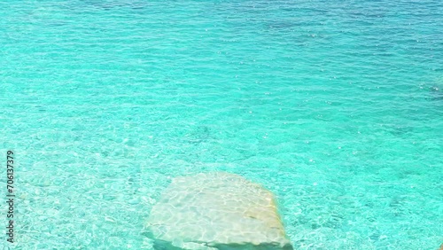 Seychelles beach at Magganitis, Ikaria island Greece, Icarian sea of crystal clear green turquoise water, underwater rocks high angle aerial view photo