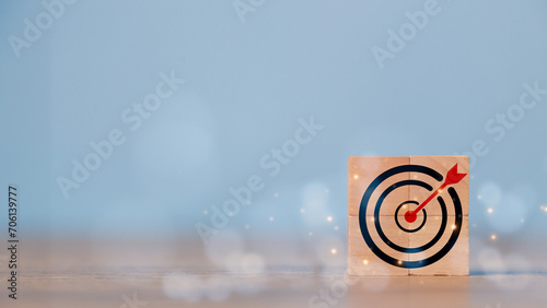 Business goal and success concept. Focus on a goal and achieve a successful business. Initiation for planning to reach the target. Darts target aim icon on wooden cubes with Copy space. photo