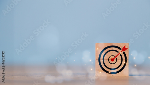 Business goal and success concept. Focus on a goal and achieve a successful business. Initiation for planning to reach the target. Darts target aim icon on wooden cubes with Copy space.