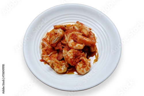 Schezwan Prawns in white plate with wooden background. Schezwan Prawns is indo-chinese cuisine curry dish with prawns or shrimps roasted in Schezwan Sauce. Udang saos Padang 
