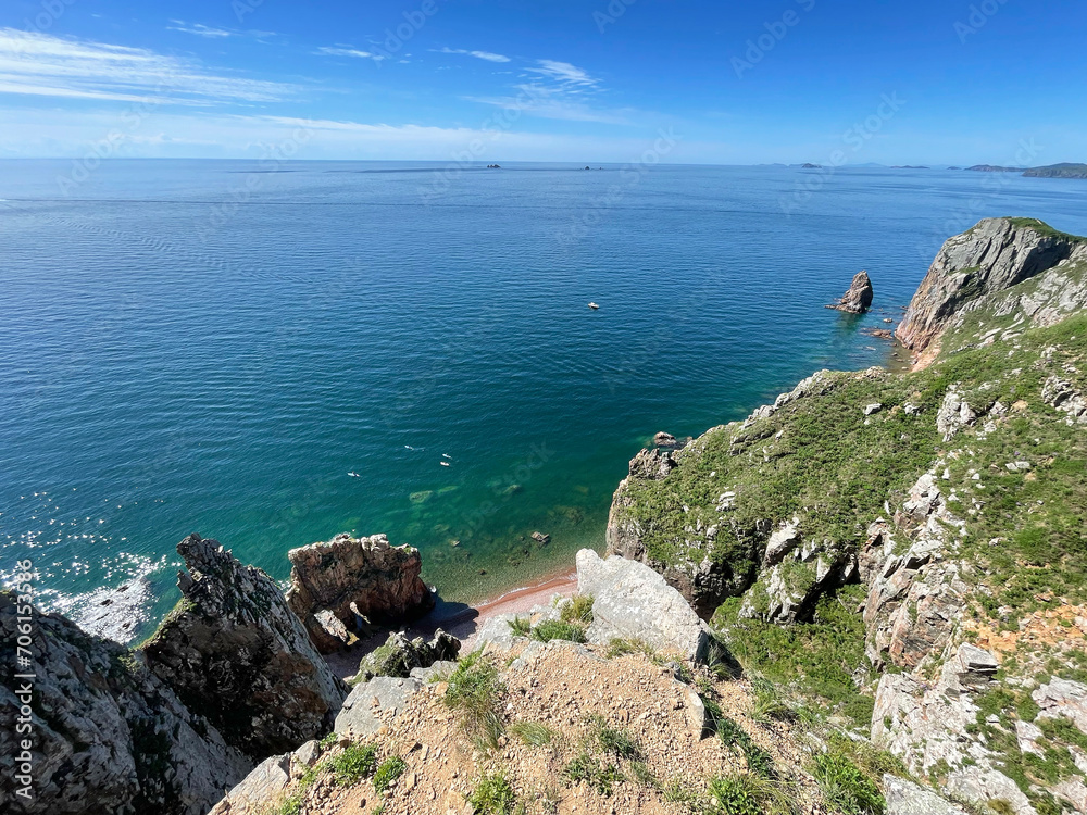 The beautiful Southeastern coast of the island of Shkota in August in sunny weather. Russia, Vladivostok city