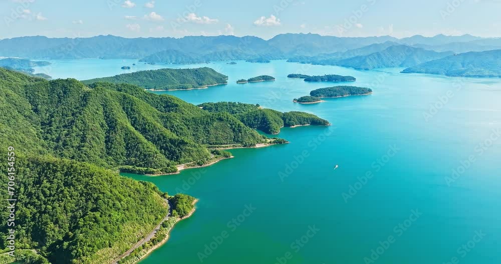 Aerial video of clear lake water and green mountain natural landscape in Hangzhou. Drone shooting forward.