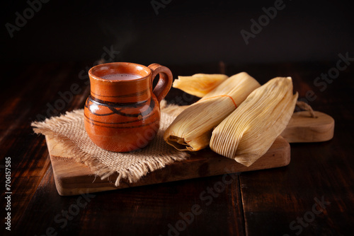 Tamales. hispanic dish typical of Mexico and some Latin American countries. Corn dough wrapped in corn leaves. The tamales are steamed. photo