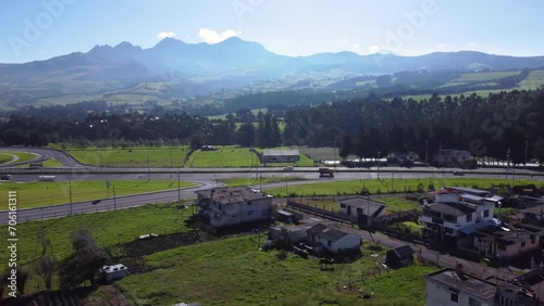 Ecuador Panmericana highway E35 with volcano Ruminahui backdrop aerial slide shot photo