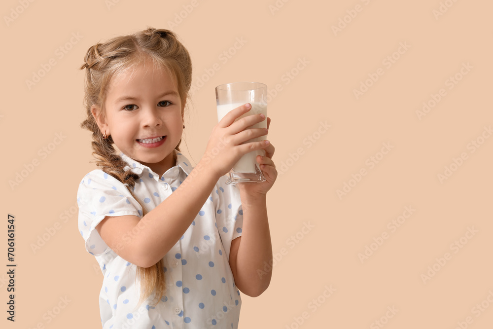 Cute little girl with glass of tasty milk on beige background Cute little girl with glass of tasty milk on beige background